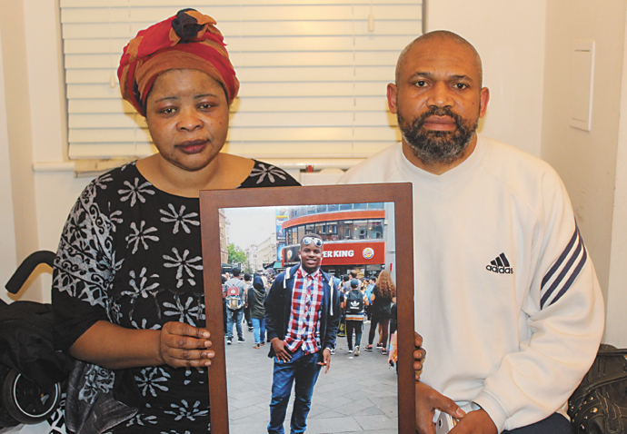 Six months on, mother still waiting to see report on son’s basketball accident death Parents Carlotta Jose and Jeff Mpunga with a photograph of Brian Mpunga