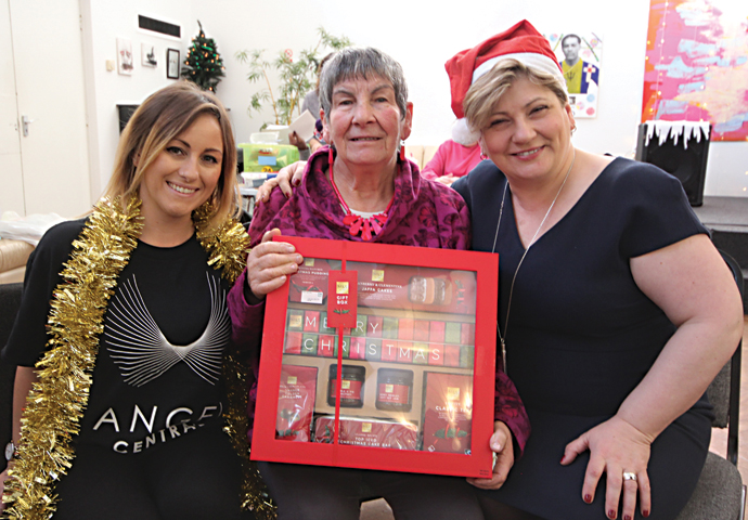 Antonietta Tempesta 82 receives a hamper from Laura Edwards of Angel Central and Emily Thornberry