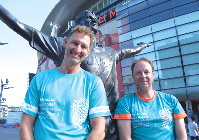 Tony Adams MBE (left) with Lewis Owens (right) next to Tony's statue at the Emirates Stadium.