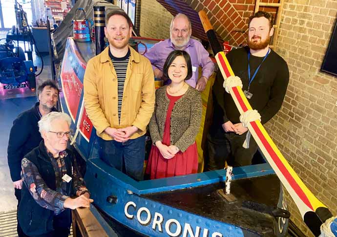 Martin Sach (in purple) with volunteers on restored boat