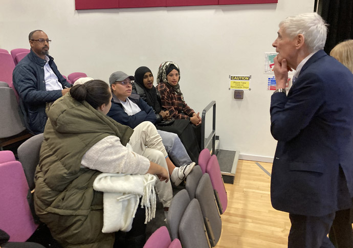 Schools merger: parents quiz education chiefs John Beighton speaking with parents