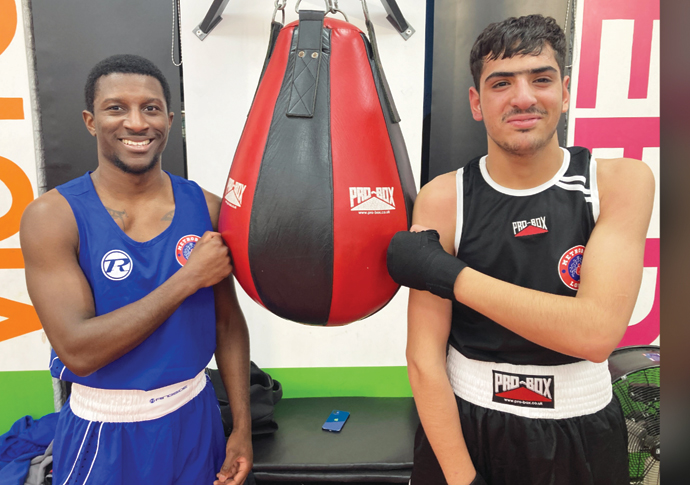 Boxing club on hand to help Afghan teen Boxing coach Mickel Nelson with Abdul Baset ahmedi (right) copy