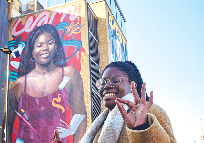 That’s me up there! Maria Epam in front of her mural near the Lomdon Met University