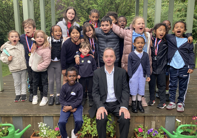 Headteacher praises parents’ campaign to save school as he steps down Greg Crawford with pupils at Pooles Park