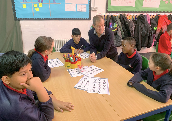 Alastair Campbell with kids in classroom