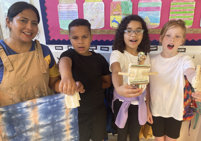 Music and the art of success in learning maths and English Parent Tatiana Hernandez leading a screen printing class with year 5 students Jaylen Flora and Ruby