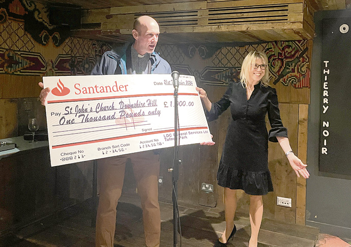 ‘Garden shed’ funeral director toasts past year LDC Funerals with cheque for St John's Chjurch